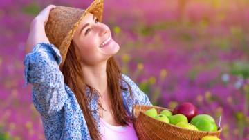 Attractive girl with apples basket