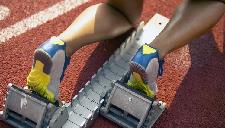 Athletic Feet of Runner Positioned at Starting Block